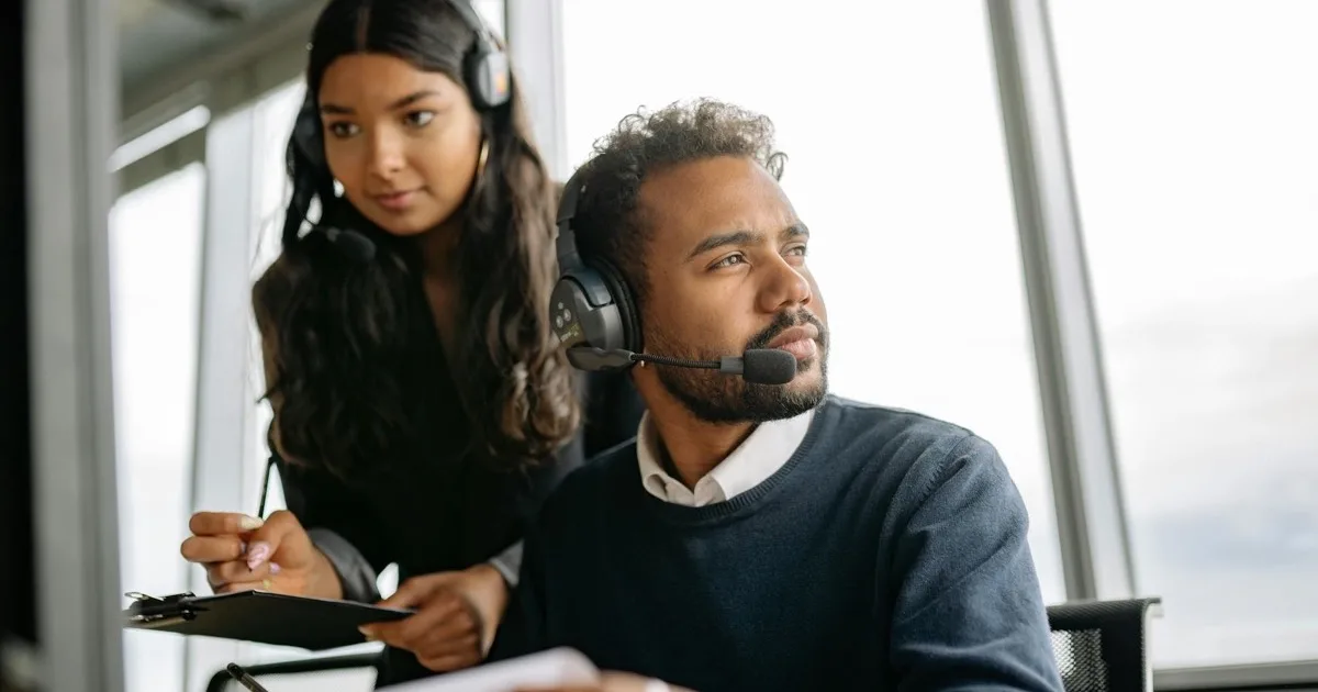 IT technician monitoring systems at a 24/7 support workstation
