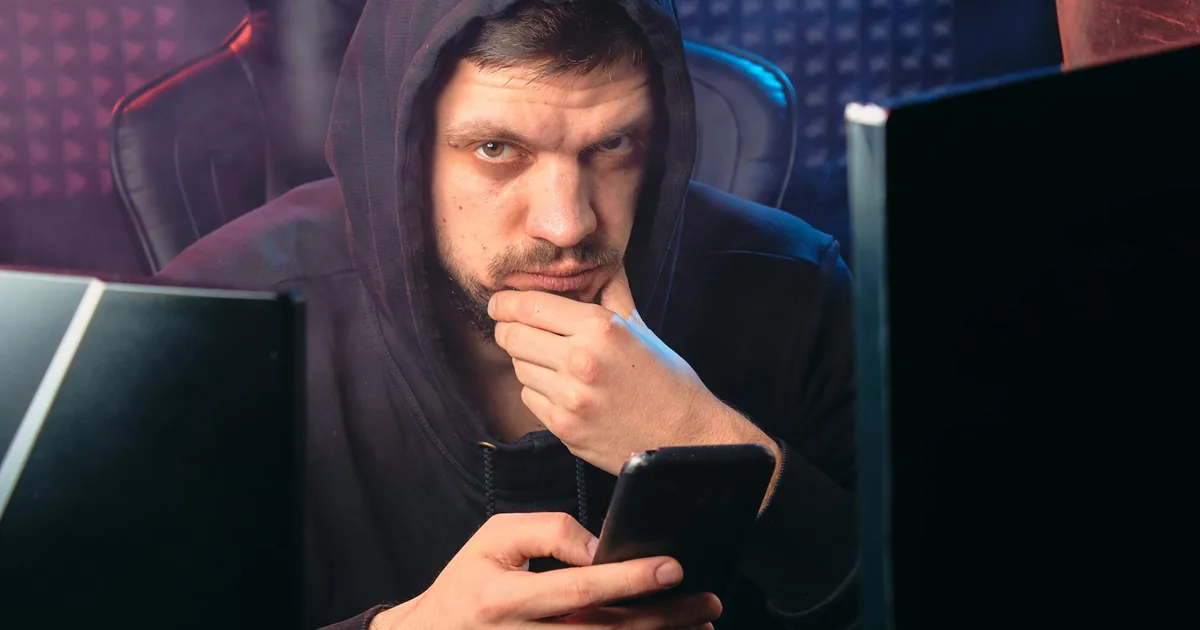 A person reviewing email on a laptop in an office
