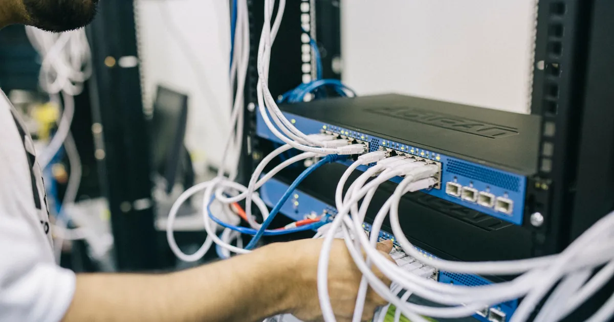 Network switch being cabled in an office rack