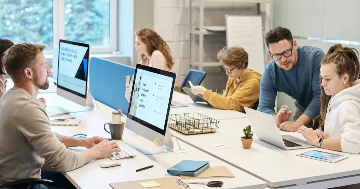 Reliable IT support pays for itself in recovered productivity Small business team working productively on supported computers