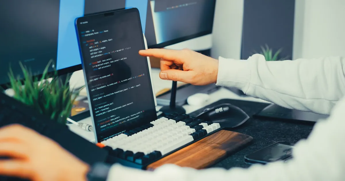 Manual testers follow live application flows that scanners only pattern-match Tester pointing at application code on a tablet during a manual review