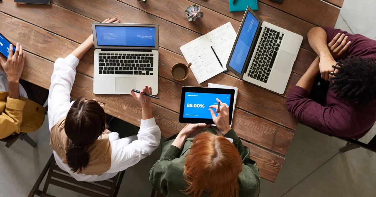 A small office already has more endpoints than the spreadsheet admits Mixed laptops, tablets, and phones on a small-business table