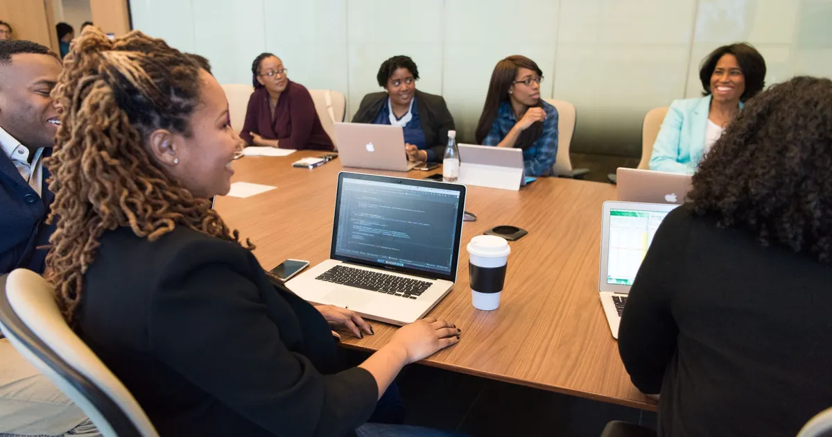 Laptop and meeting notes on an office table