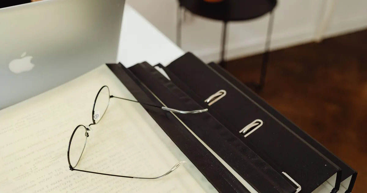 Laptop and file folders on a desk