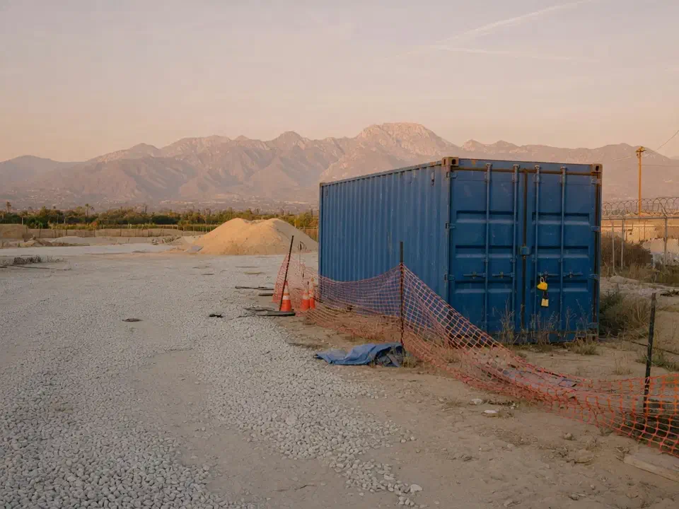 Locked jobsite conex on a Southern California lot at dusk